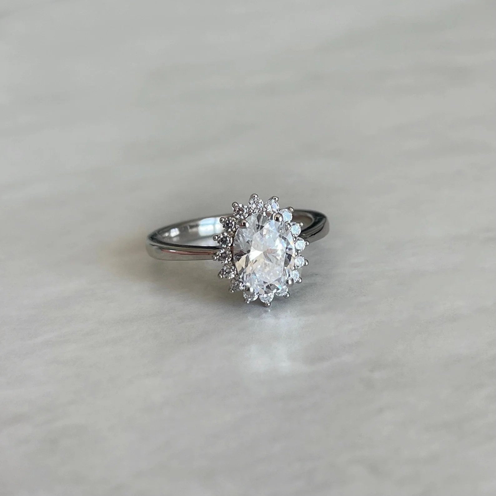 Elegant Round Crystal Ring in rhodium-plated silver with a sparkling cubic zirconia center.