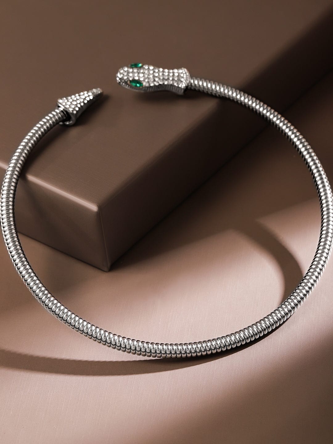 Elegant snake-inspired choker necklace with shimmering crystals.